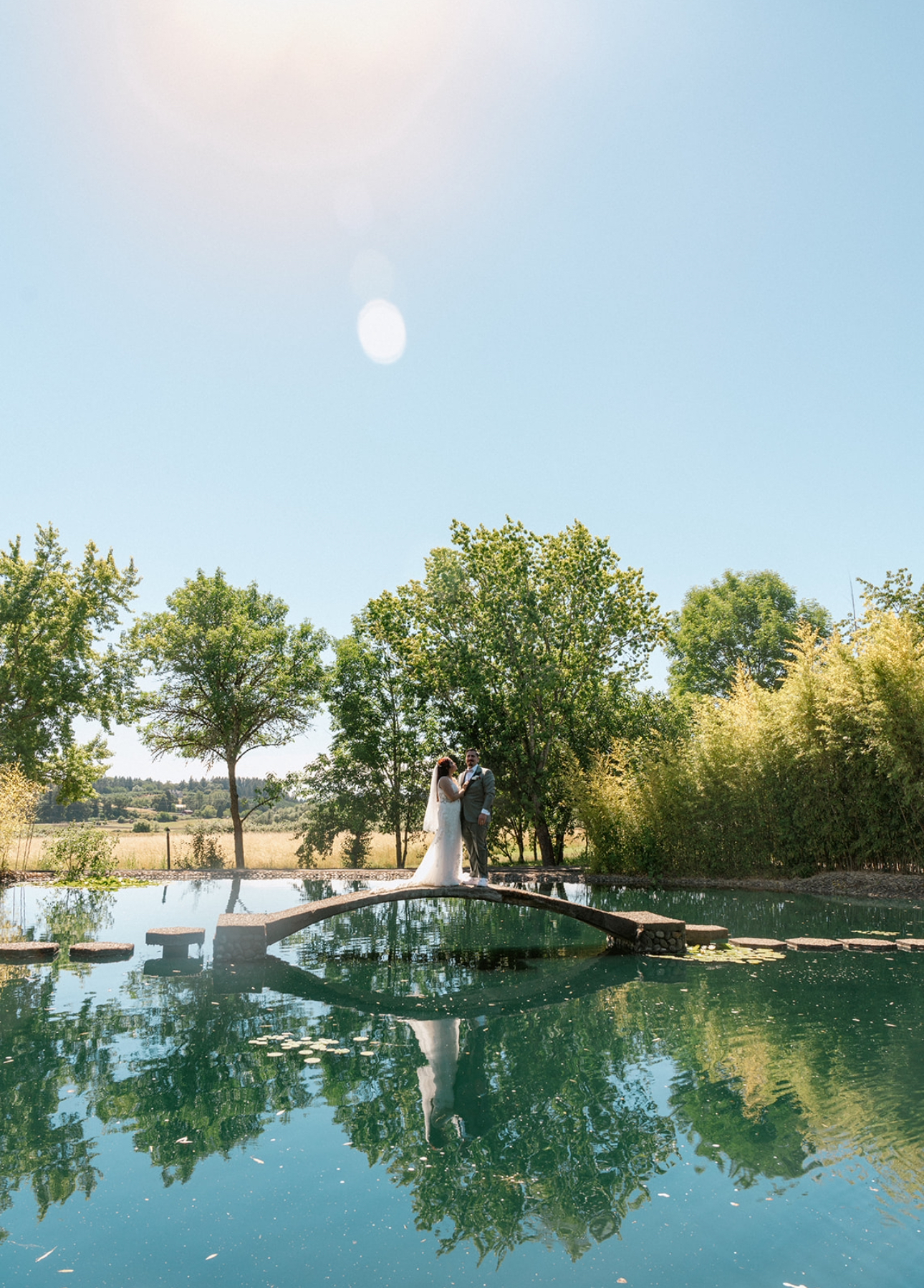 Couple by pond at The Water Oasis outdoor wedding venue in Newberg, Oregon.